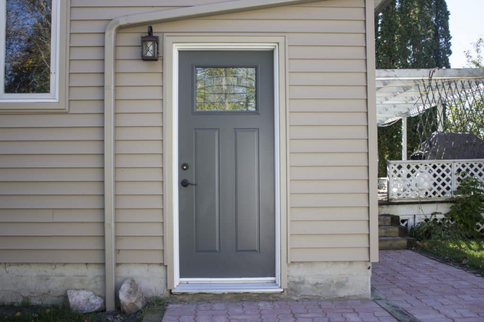 Quality Contracting installer verifying structural integrity and building code compliance during an entry door installation in West Nipissing.