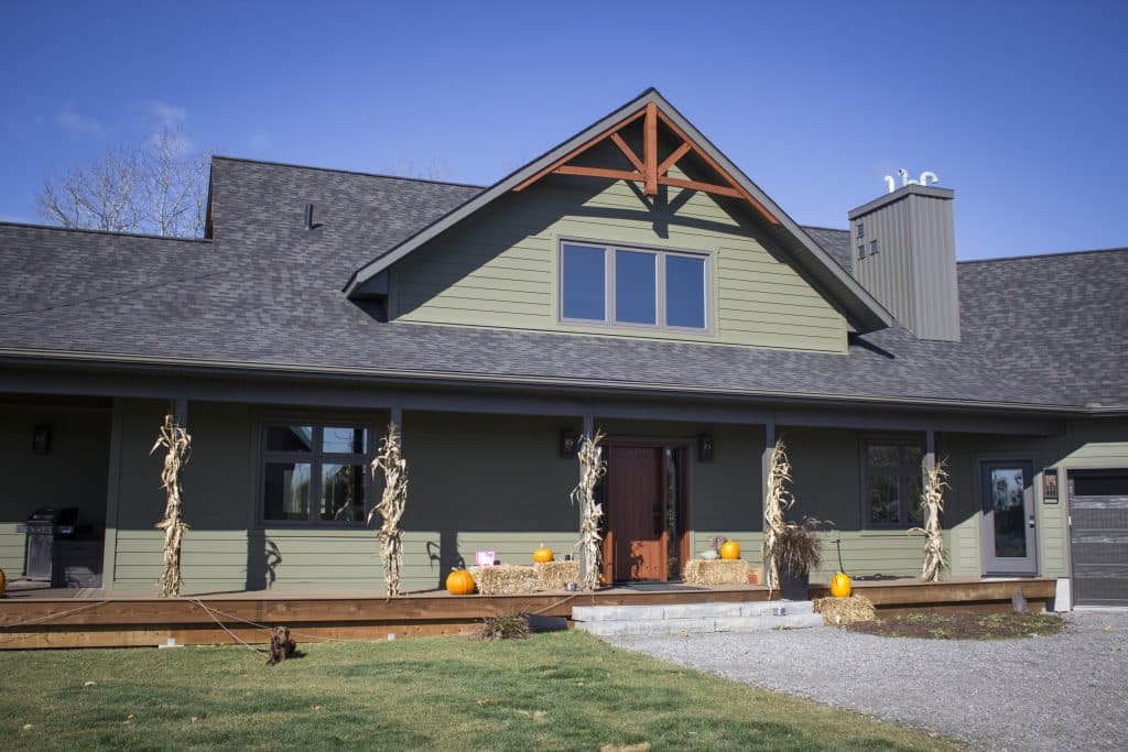 Quality Contracting team explaining the window and siding installation schedule to a homeowner.
