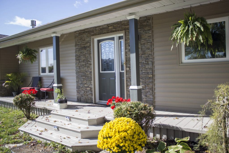 A lakefront cottage in Temagami, Ontario, upgraded with new energy-efficient windows, a secure entry door, and durable vinyl siding installed by Quality Contracting.