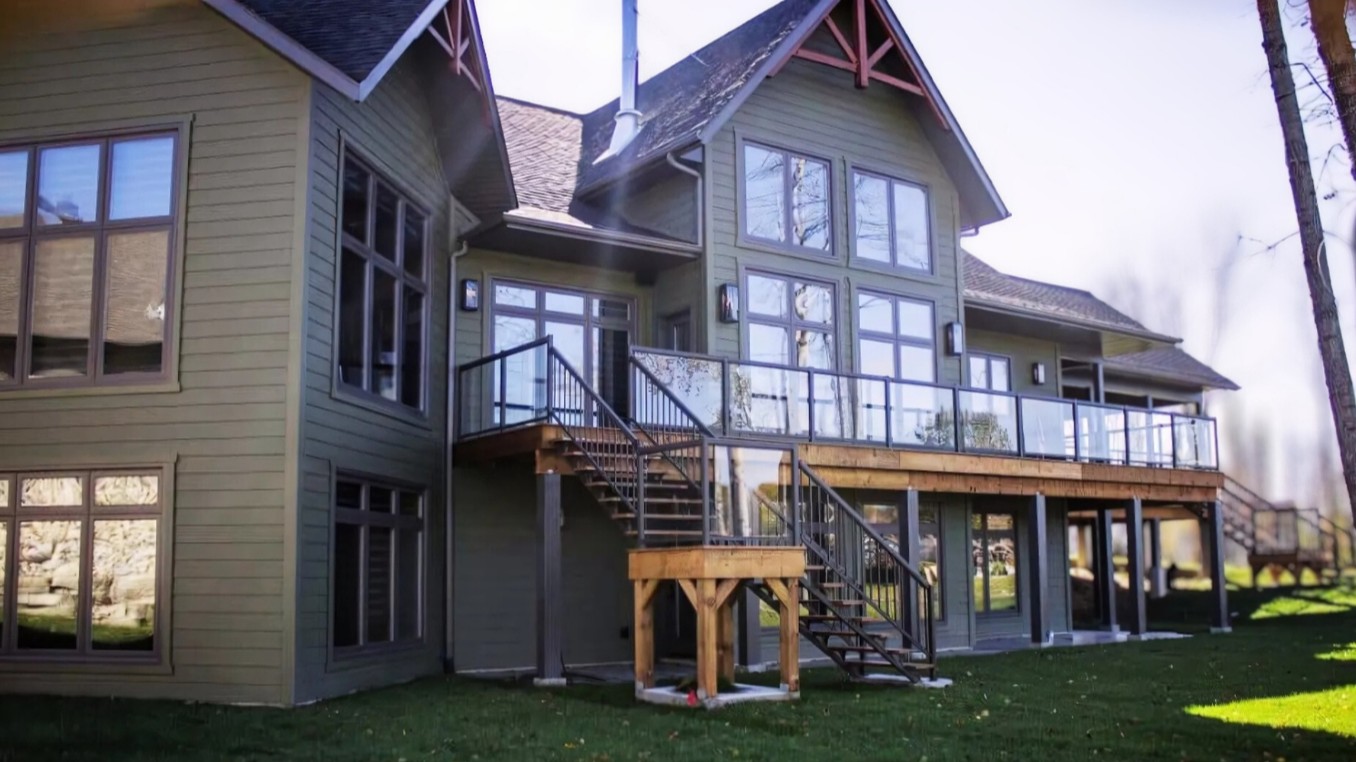 A home in Warren, Ontario, featuring new energy-efficient windows, a stylish entry door, and durable vinyl siding installed by Quality Contracting.